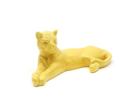 A Mintons pottery figure, c.1890-1910, of a yellow glazed pottery lioness, modelled resting, moulded mark 'Mintons England', 