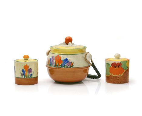 Two Clarice Cliff pottery preserve pots and covers, 'Crocus' and 'Nasturtium' pattern, printed marks,9.5cm hightogether with 
