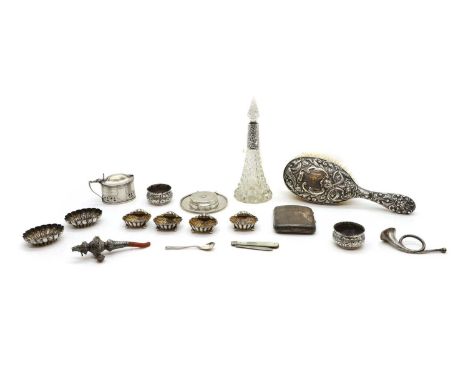 A collection of silver items to include a silver backed brush, a silver mounted scent bottle, a teether and whistle, with a c