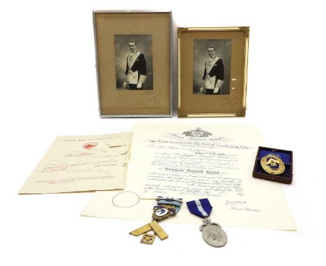 A collection of Masonic Memorabilia, comprising three silver, silver gilt and enamelled medals, each boxed, and easel back fr