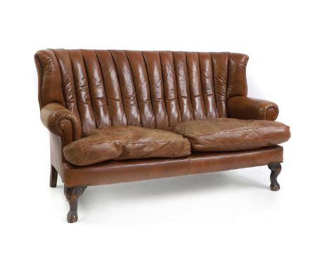 A leather upholstered sofa of recent manufacture, with studded brass decoration terminating on claw and ball feet,173cm wide7
