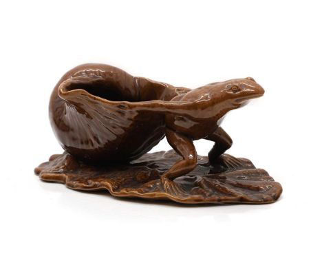 A Watcombe Pottery glazed novelty stand, c.1890, in the form of a frog pulling a shell, stamped marks, 21cm wideCondition Rep