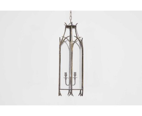 A patinated brass hall lantern in the Gothic taste, of recent manufacture, with bevelled glass panels and three candle sconce