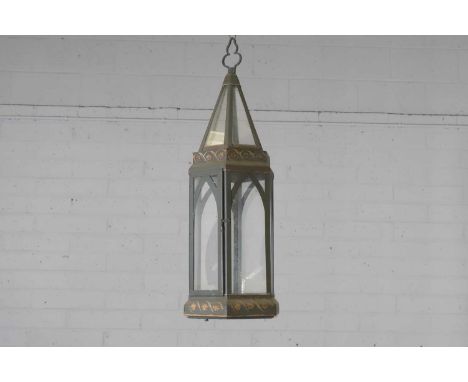An hexagonal toleware metal hall lantern, late 19th century, with a conical mount, arched glazed panels, and painted scrolls 