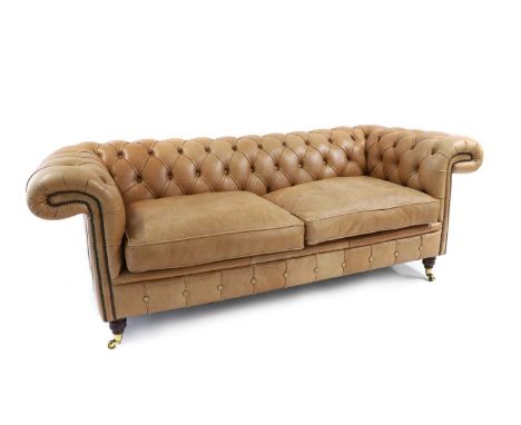 A chesterfield settee of recent manufacture, upholstered in cognac leather with buttoned back and arms above a cushioned seat