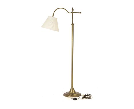 A brass reading lamp, 20th century, with adjustable light sconce, pineapple finials, on a weighted circular standCondition Re