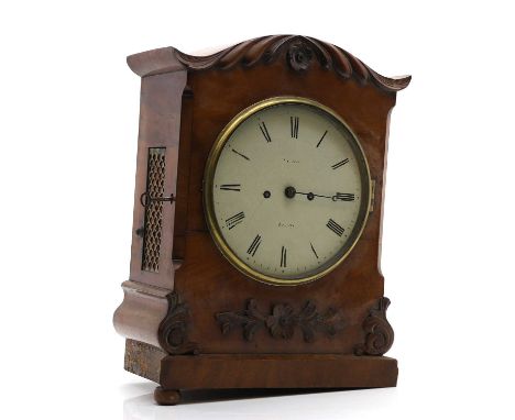 A Regency mahogany mantel clock, the white circular dial with Roman numerals, with a mahogany case with curved leaf detail,42