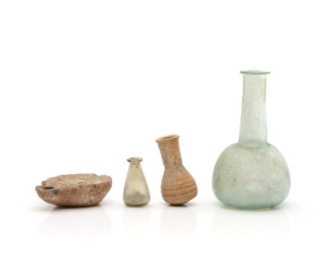 A Roman lustre glass bottle, 14cm high, together with another small Roman glass vessela terracotta vial and an oil lamp, 5cm 