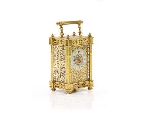 A French gilt metal carriage clock,  late 19th century, the circular enamel chapter ring with arabic numerals within an archi
