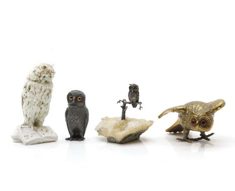 A group of for owl ornaments  to include a silver plated peppertte together with a brass desk weight, a porcelain model of an