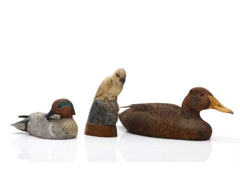 Two carved wood decoy ducks the first by John Schmauder, carved, painted, and burnt pine, signed 'The Wooden Duck, 1985, John