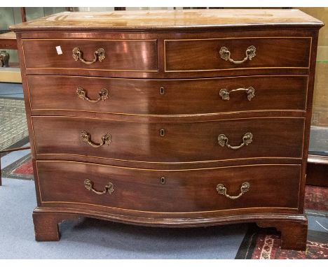 A George III style mahogany serpentine fronted chest of drawers, 20th Century, comprising two short over three long graduated