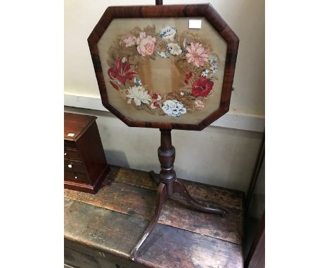 A 19th Century polescreen with a woolwork floral panel on a tripod base, height 148cm