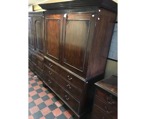A George III mahogany linen press, circa 1800, dentil cornice, blind fret chinoiserie frieze, twin panelled doors opening to 