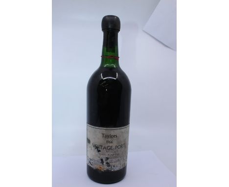 A bottle of Taylors Vintage Port 1966, Creamy Toffee And Brulee, Flavours Ruby in Colour.&nbsp;Damage to label Wax intact, no