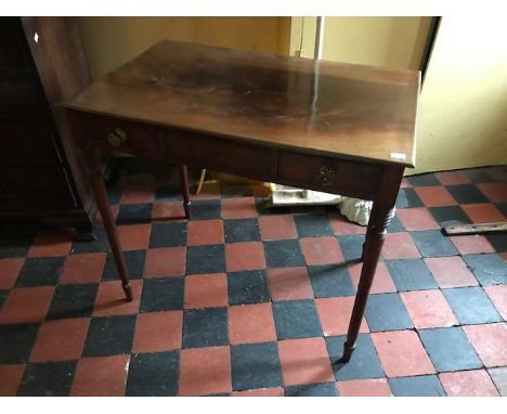 A George III mahogany writing table, circa 1810, two offset frieze drawers, ring turned tapered legs, width 82cm