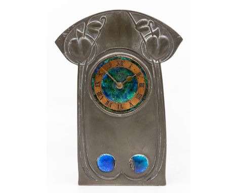Archibald Knox, retailed by Liberty & Co.; a pewter and enamel clock, circa 1905, of arched rectangular form, the dial with R