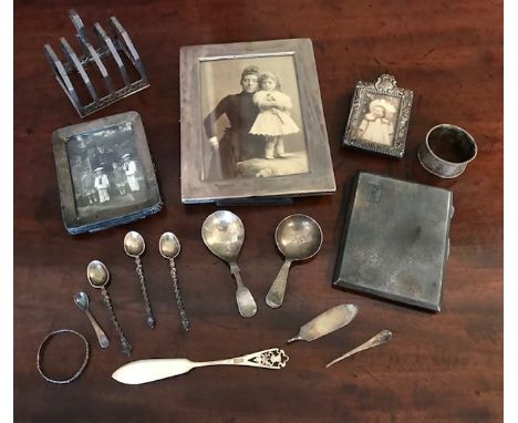 A parcel of assorted silver, to include three easel photograph frames of varying sizes, a five bar toast rack, pocket cigaret