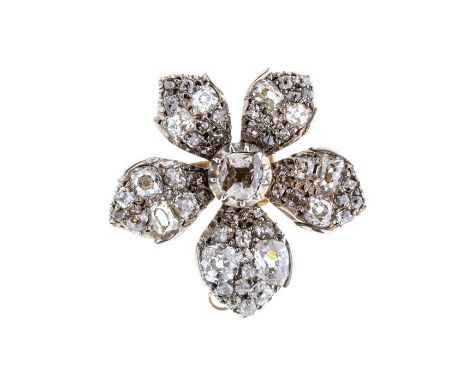 A early 20th Century diamond set flower brooch, comprising a claw set central old cushion cut diamond, each petal set with ol