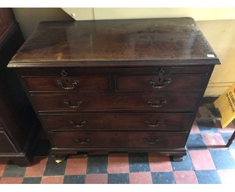 A George III mahogany chest of drawers, circa 1760, moulded top, brushing slide, two short over three long drawers with brass