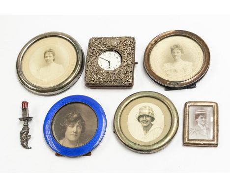 A group of silver to include: a late Victorian silver mounted watch mount, the cover applied with silver repousse with scroll
