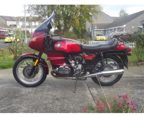 A 1980 BMW R100RS, registration number JKU 409W, frame number 6075555, engine number 6075555, Smoke red. With 47,500 recorded