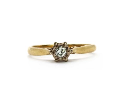 An 18ct gold single stone diamond ring, a brilliant cut diamond grain set to an illusion collet, to tapered chenier shoulders