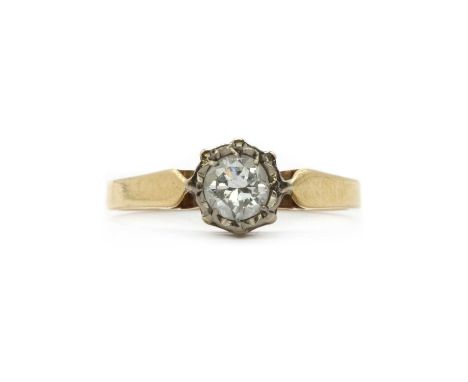 A gold single stone diamond ring,a brilliant cut diamond, grain set to an illusion collet, to chenier shoulders and a plain s