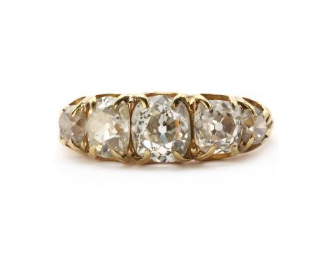 A Victorian gold five stone diamond ring, a row of graduated old mine cut diamonds, claw set, to tapered shoulders and a plai