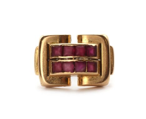 A gold ruby ring, two rows of square step cut rubies, possibly synthetic, channel set to an arched collet, to 'C' shaped shou