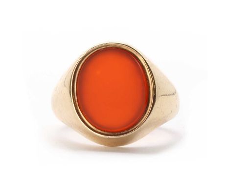 A 9ct gold cornelian signet ring, with an oval cornelian tablet, rub set, to tapering shoulders and a 'D' section shank, 5.84