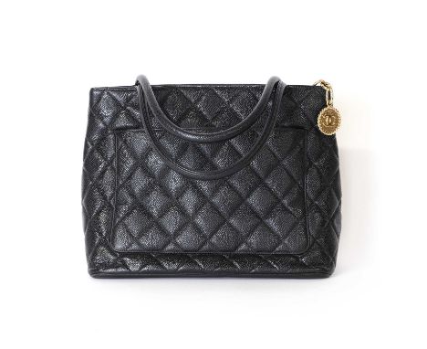 A Chanel black leather medallion tote,dual rolled handles, gold tone hardware, opening to interior zip and slip pocket, seria
