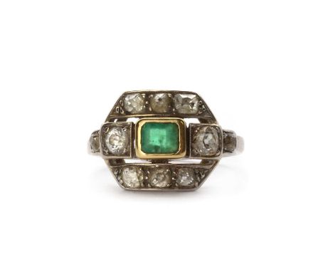 An Art Deco emerald and diamond ring, a central emerald cut emerald, rub set to a gold collet, to a pierced head with an old 