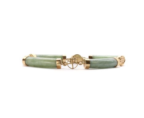 A 14ct gold carved jade bar link bracelet,with curved cylindrical jade bars, with gold end caps, joined by pierced Chinese ch