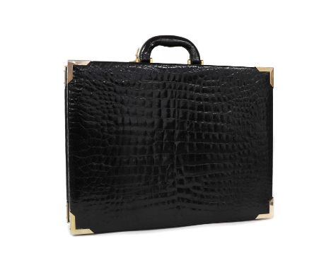 A Vintage black crocodile embossed leather briefcase,gold tone hardware, dual lock to the front, opening to interior pockets,
