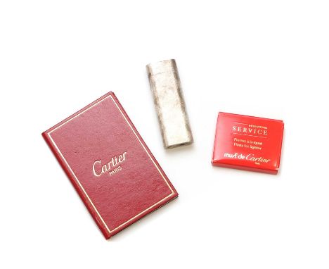A Must de Cartier gas lighter, of ovoid form with a textured finish, serial no. 43875E, 7cm long, with instruction booklet, c