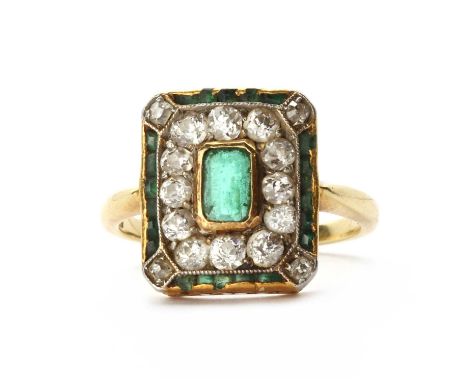 A Continental early 20th century gold emerald and diamond cluster ring, an emerald cut emerald rub set at the centre, to surr