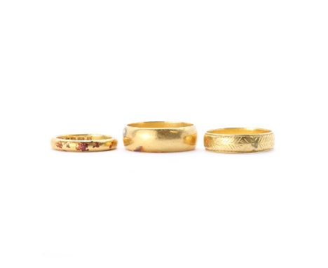 Three 22ct gold wedding rings, comprising a 'D' section wedding ring, London 1932, 3.25mm wide, a 'D' section wedding ring, B