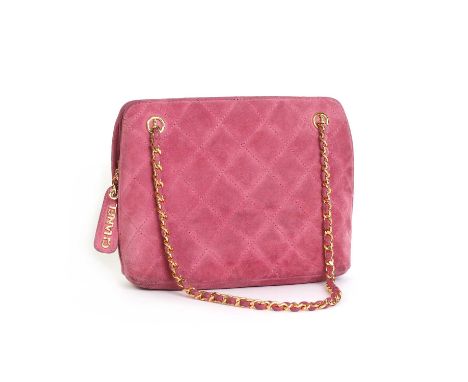 A Chanel pink suede shoulder bag,gold tone hardware, dual chain and suede interlinked straps, zip closure opening to pink lea