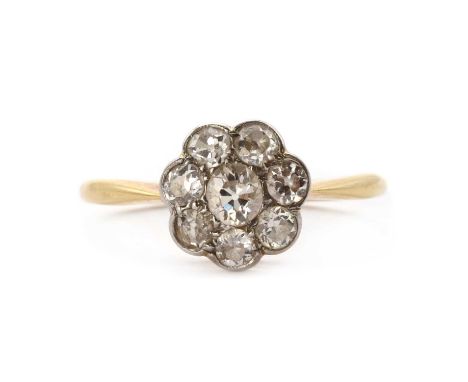 An early 20th century diamond daisy cluster ring, a cluster of old Swiss cut and old eight cut diamonds, grain set to a scall