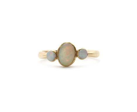 A 9ct gold three stone opal ring,an oval opal cabochon to round opal cabochons either side, bezel set to a plain 'D' section 