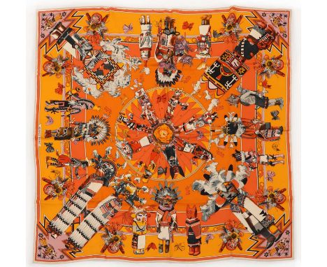 An Hermès scarf, Kachinas,by Kermit Oliver, 1992, orange ground with spiritual design, with 'histoires de carres' spring-summ