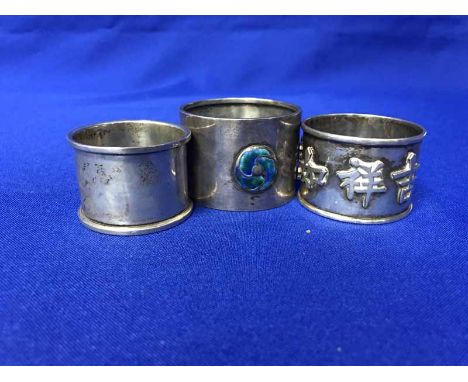 THREE SILVER NAPKIN RINGSincluding an arts and crafts enameled example by William Hair Haseler