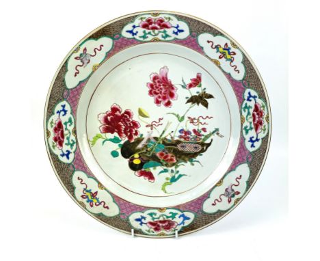 A 19th century famille rose 'covert eight immortals' charger, 39cm diameter, painted to the central medallion with attributes