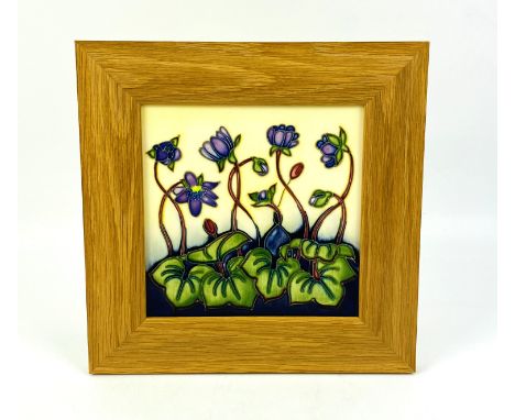 An oak framed Moorcroft pottery square plaque "Hepatica" pattern designed by Emma Bossons, impressed marks to the reverse. 24