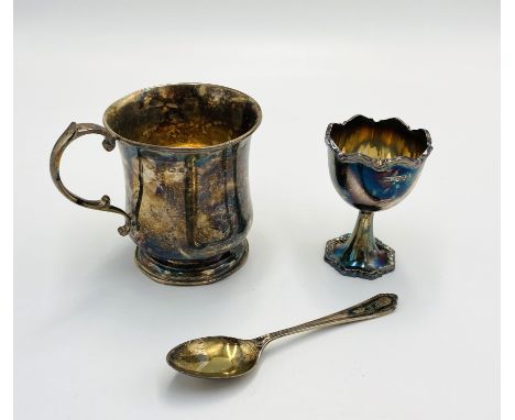A silver Christening tankard, in box, 85g; a silver egg cup and spoon 70g. Estimate: £90-120