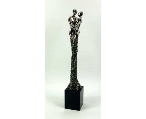 A contemporary polished silvered metal sculpture titled "Two Souls" by Jennine Parker, raised upon a black marble base.Limite