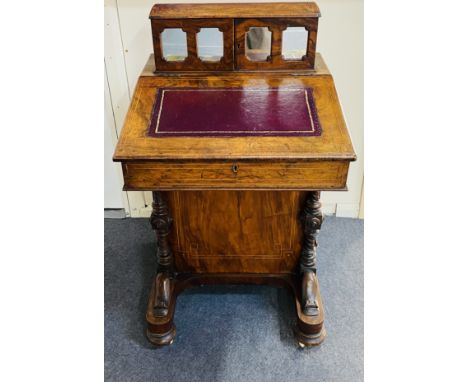 A Victorian inlaid walnut Davenport with carved decoration and of typical form, with four drawers to one side, below a leathe