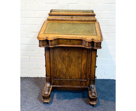 A Victorian burr walnut shaped top Davenport of typical form with four drawers to one side and a inset leather writing surfac
