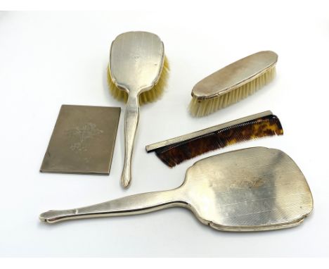 A silver backed part dressing table set comprising hand mirror, two brushed and comb; together with a silver plate folding ph